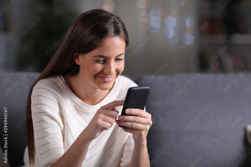 Happy teen browsing mobile phone content in the night Happy teen browsing mobile phone content in the night