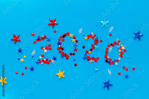 2020 New Year card. Confetti on blue background top view