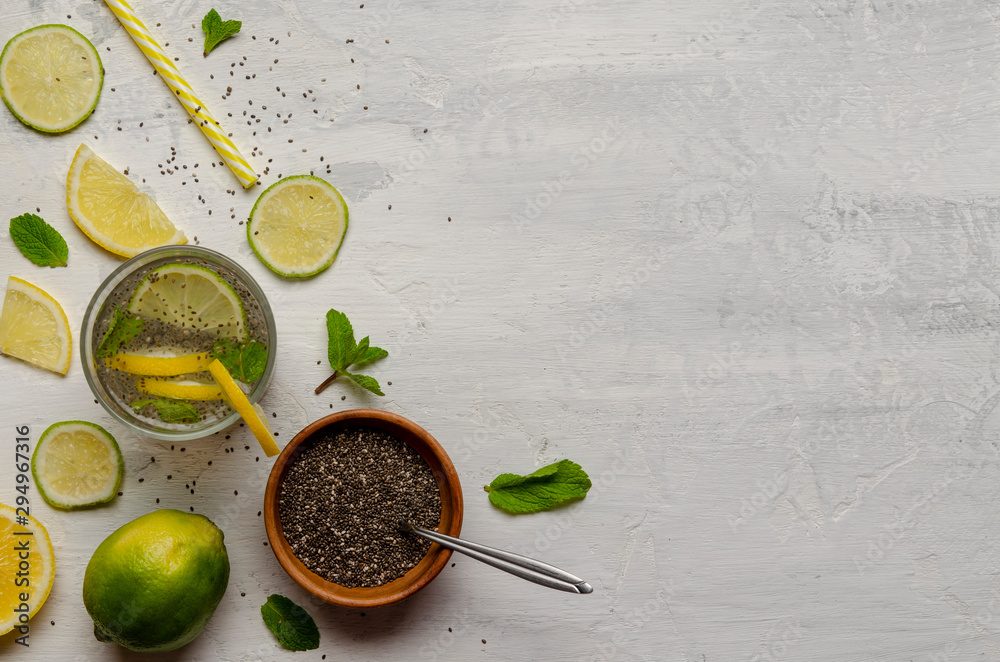 Chia water drink with lemon and mint on cement background Chia water drink with lemon and mint on cement background