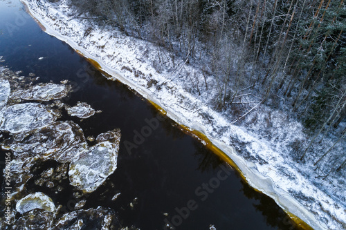 Aerial view of river with floating ice in cold winter. River Gauja, Latvia.