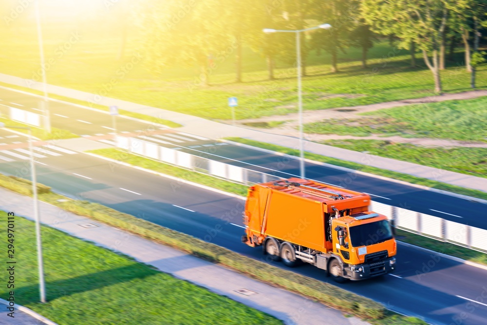 Garbage truck . Orange garbage truck . Urban recycling waste and garbage services