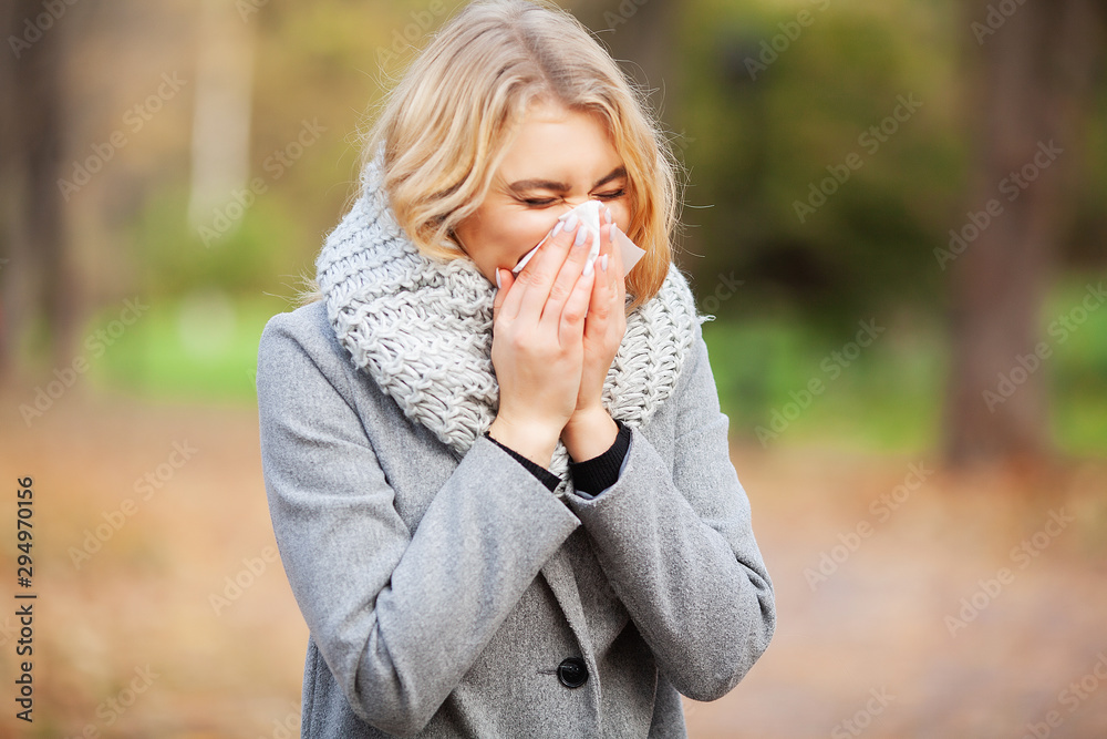 Woman portrait outdoor sneezing because cold and flu Woman portrait outdoor sneezing because cold and flu