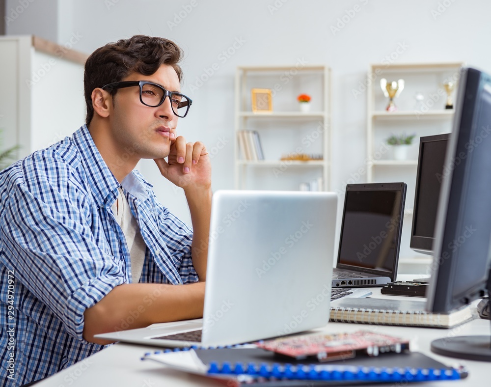 Businessman sitting in front of many screens Businessman sitting in front of many screens