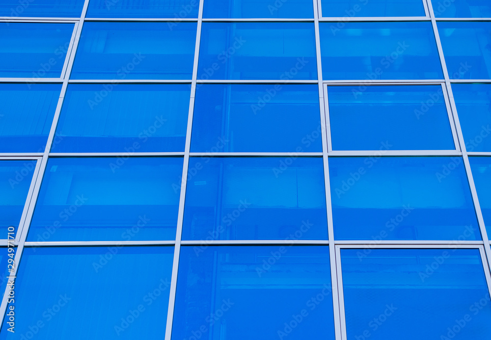 Square blue windows of the business center. Theme of modern geometric architecture and urbanization