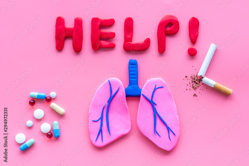 Treat lung diseases. Word help, organ and pills on pink background top view Treat lung diseases. Word help, organ and pills on pink background top view