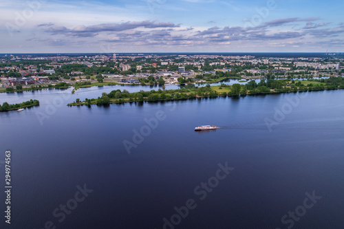 Tourist ship travels down the river Daugava in Riga, Latvia. Captured from above with a drone.