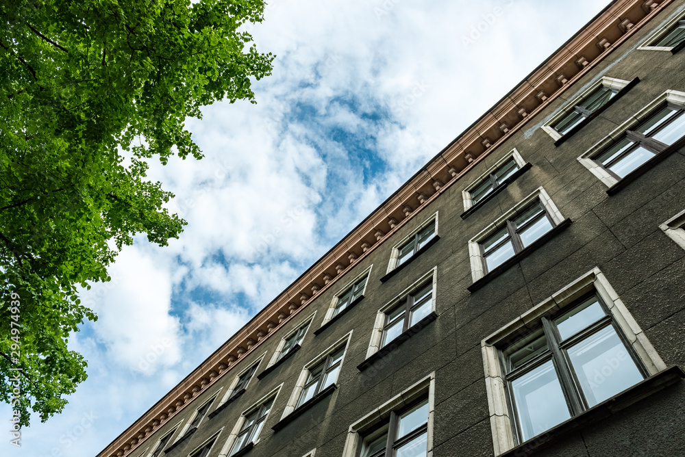 Fototapeta premium Old apartment building with blue sky