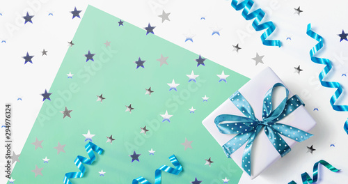 Gift box with confetti and ribbons - overhead view flat lay