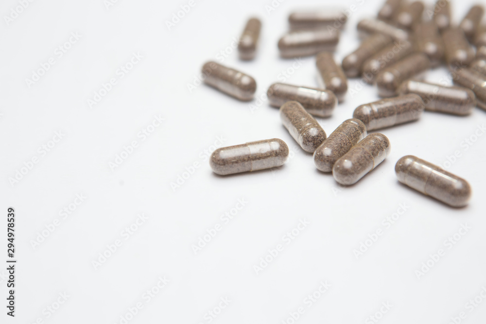 Selective focus of Many medicine capsules on white background Selective focus of Many medicine capsules on white background