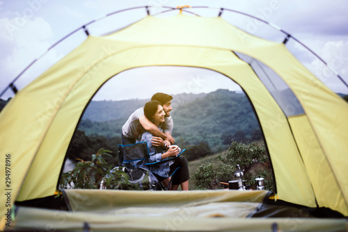 Couple lover hugging together outside tent feeling happy and smiling,Enjoying camping