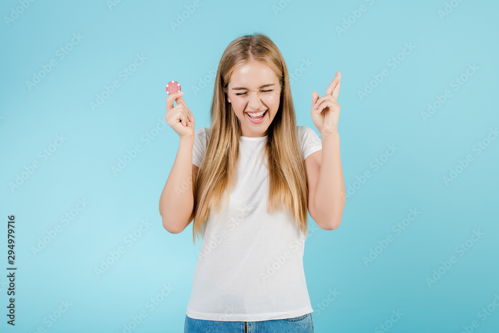 beautiful smiling blonde woman with poker chip from online casino isolated over blue