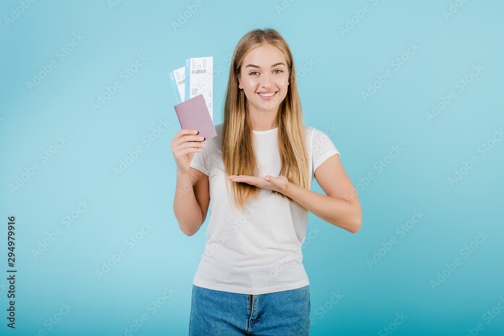 blonde woman with plane tickets and passport isolated over blue blonde woman with plane tickets and passport isolated over blue