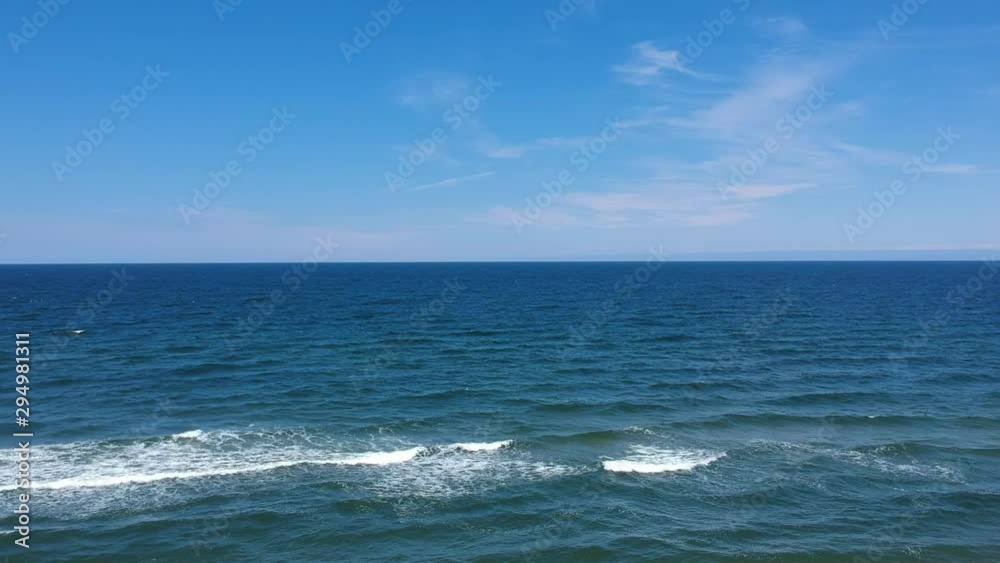 View of the calm Baltic Sea and small waves. View of the calm Baltic Sea and small waves.