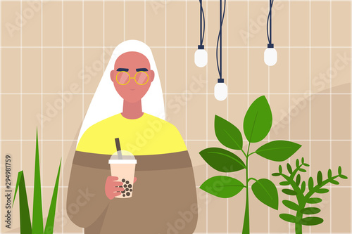 Young female character holding a cup of boba bubble tea to take away in a modern hipster interior with plants and tile pattern