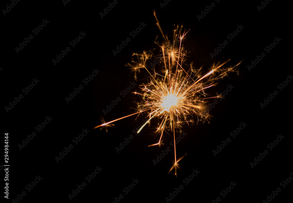 Sparkler and light bokeh background.Abstract and brightly colorful firework in the celebration and anniversary festival.Merry Christmas and New year party light over night sky.