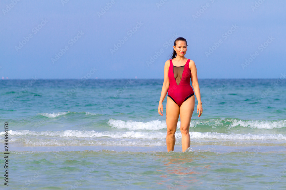 Woman with bikini crimson show beautiful on beach Woman with bikini crimson show beautiful on beach