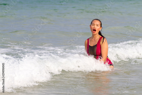 Woman with bikini crimson relax wave on beach © suthin3