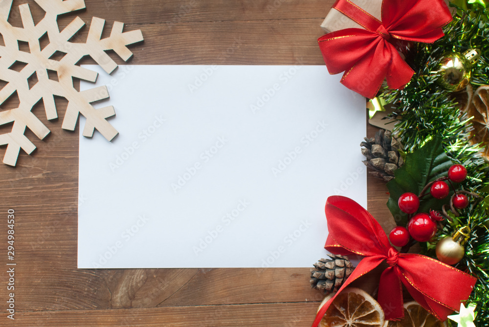 Christmas background with decorative composition of green tinsel, dried oranges, red berres, pine cone, gift with red bow and stars on wooden board. Happy new year. Christmas background with decorative composition of green tinsel, dried oranges, red berres, pine cone, gift with red bow and stars on wooden board. Happy new year.