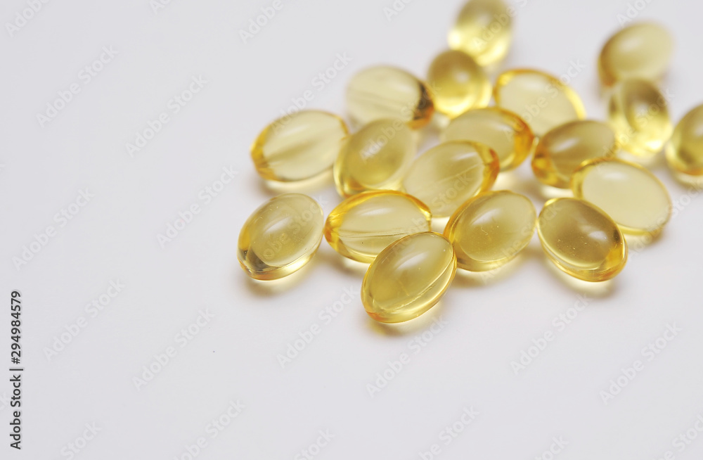 Fish fat in capsule on light background. Fish fat in capsule on light background.