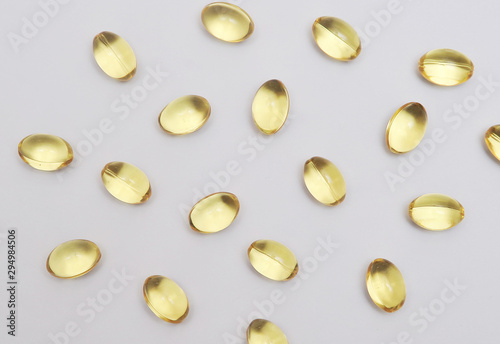 Fish fat in capsule on light background.