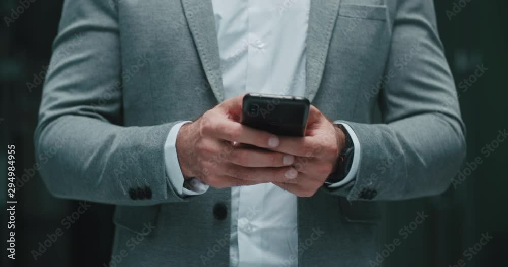 Closeup shot of businessman walking in office hall dealing with problems on his phone, chatting and talking - modern business concept 4k footage Closeup shot of businessman walking in office hall dealing with problems on his phone, chatting and talking - modern business concept 4k footage