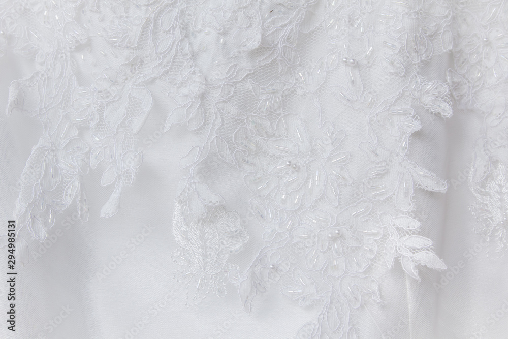 Obraz premium Details of the bride dress fabric and beautiful embroidery wedding concept used as a background for illustrations