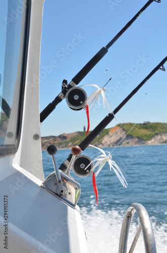 Fishing poles, reels and lures on a charter fishing boat.