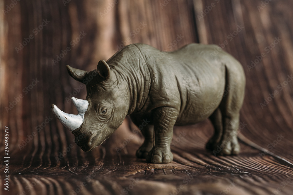 Fototapeta premium figure of a toy Rhino on a wooden background