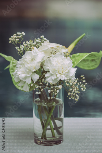 White flowers in vases decorate a table