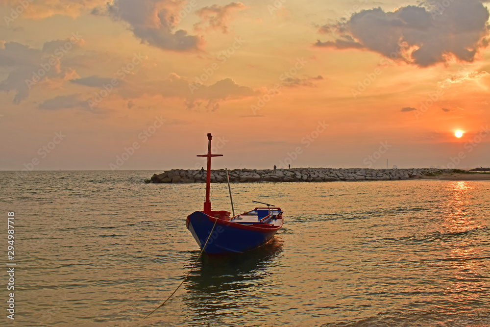 Naklejka premium fishing boat At the coast There are many fishing boats at the pier. During the sunset
