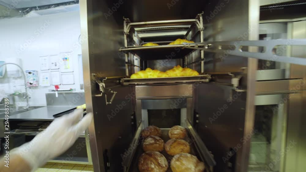 POV of baker pull out plates of croissants from the oven 4K. Baker point of view pulling the plate in focus from inside the oven. POV of baker pull out plates of croissants from the oven 4K. Baker point of view pulling the plate in focus from inside the oven.
