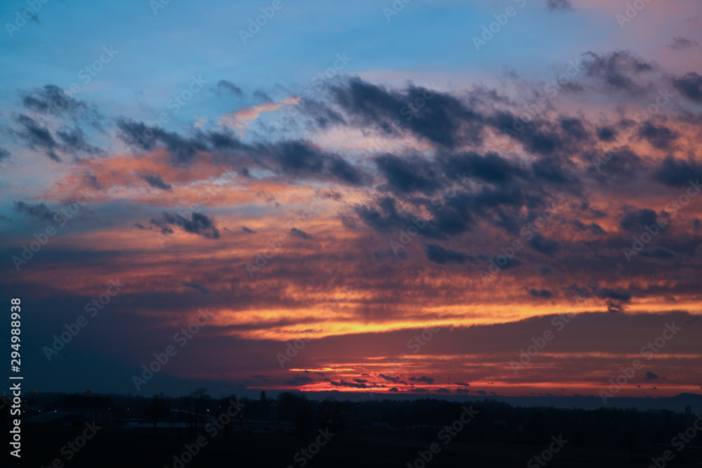 Sunset over small town with cloudscape