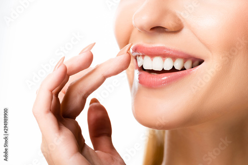 partial view of woman with white teeth isolated on white photo