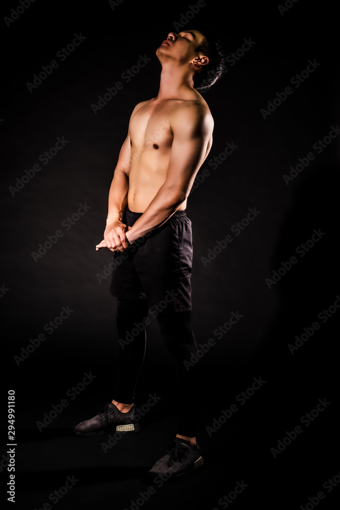 sport man at fitness gym club warm-up and stretch body before doing exercise on black backgrounds, fitness concept, sport concept sport man at fitness gym club warm-up and stretch body before doing exercise on black backgrounds, fitness concept, sport concept