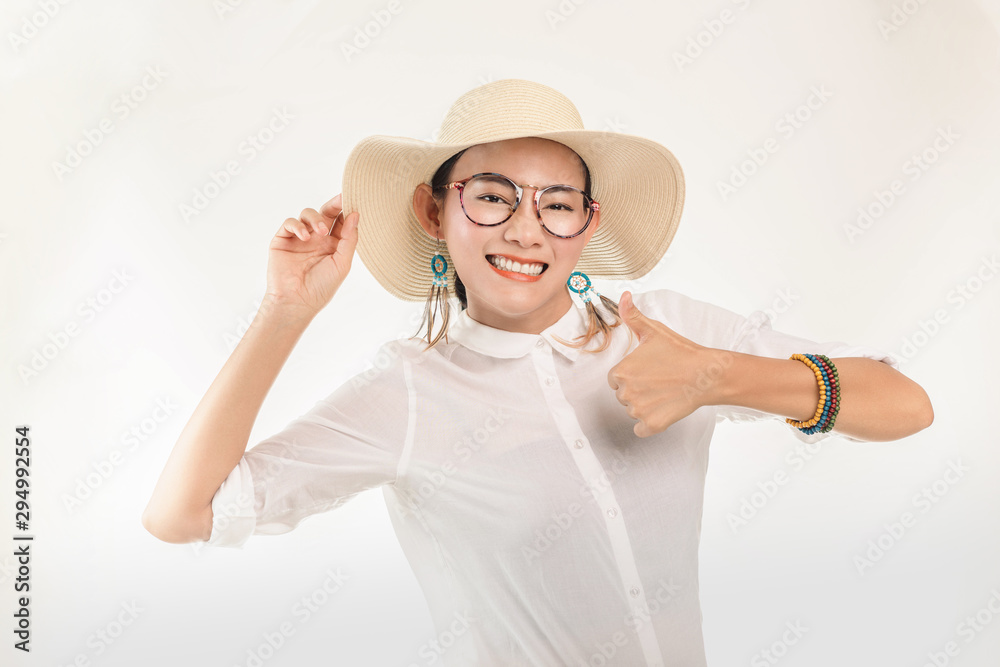 Asian women lift their thumbs up to stand out on a white background and smiling face. Asian women lift their thumbs up to stand out on a white background and smiling face.