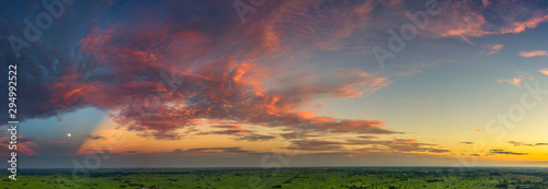 Panorama Top view Aerial photo from flying drone over village in Thailand.Top view beautiful Sunset.Sunrise with cloud over rice field.