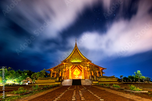 Amazing Temple Sirindhorn Wararam Phuproud in Ubon Ratchathani Province at twilight time,Thailand.Thai temple with grain and select white balance.Night sky effect for Long exposure photo taken.