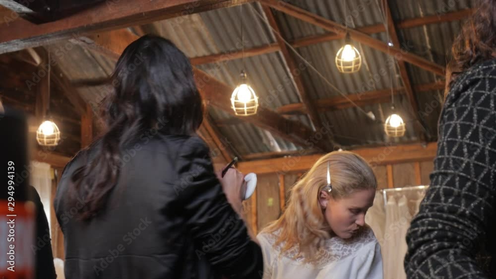 Beautiful Latina hair and makeup artist selects eye-shadow to apply to blonde model in vernacular wooden and tin room - preparation for bridal photoshoot - 4K, 23.98fps Beautiful Latina hair and makeup artist selects eye-shadow to apply to blonde model in vernacular wooden and tin room - preparation for bridal photoshoot - 4K, 23.98fps