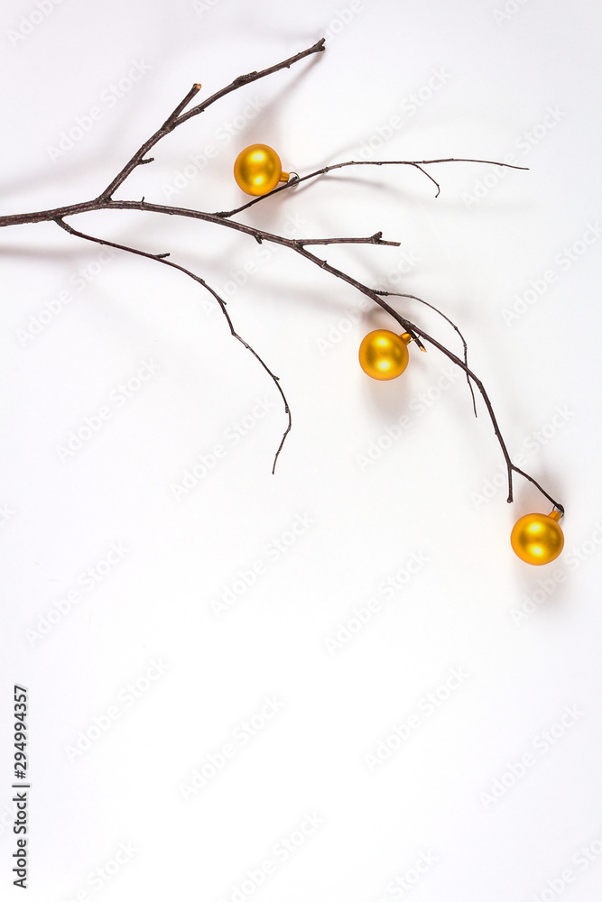 New Year nature minimal concept. Branch decorated with small christmas golden balls. New Year nature minimal concept. Branch decorated with small christmas golden balls.