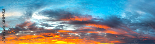 Panorama Sunlight with dramatic sky. Cumulus sunset clouds with sun setting down on dark background.Vivid orange cloud sky. © noon@photo