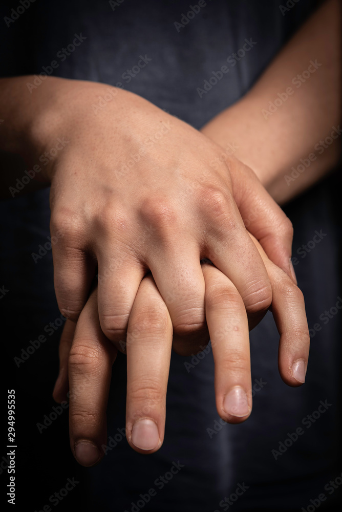 Man holding his own hands together