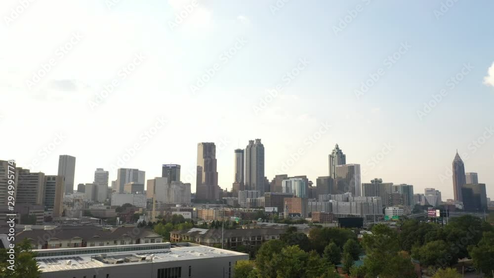 4K Ariel Drone Shot Over Skyline Buildings In Atlanta, Georgia. USA. Pretty Tall Skyline Over Tree Area and Busy Roads With Cars Driving Through. Important Tall Buildings, Sunny Day In America 4K Ariel Drone Shot Over Skyline Buildings In Atlanta, Georgia. USA. Pretty Tall Skyline Over Tree Area and Busy Roads With Cars Driving Through. Important Tall Buildings, Sunny Day In America