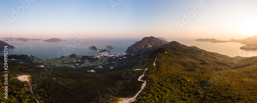 Aerial view of the sunset over the famous Dragon's back hiking trail and the Shek O village in the wild south part of Hong Kong island photo