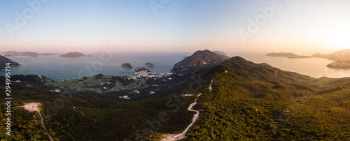 Aerial view of the sunset over the famous Dragon's back hiking trail and the Shek O village in the wild south part of Hong Kong island