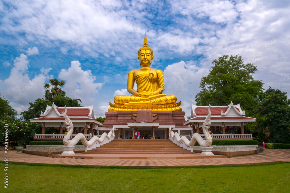 Beautiful Big Golden Buddha statue against blue sky in Thailand temple,khueang nai District, Ubon Ratchathani province, Thailand.Amazing Buddha image with sunny sky clouds. Beautiful Big Golden Buddha statue against blue sky in Thailand temple,khueang nai District, Ubon Ratchathani province, Thailand.Amazing Buddha image with sunny sky clouds.