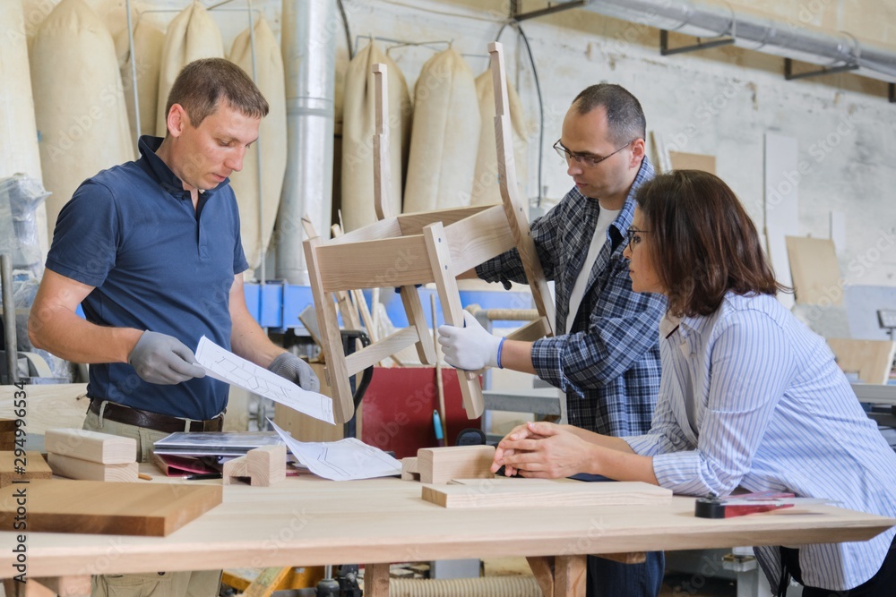 Industrial carpentry workshop, group of working people Industrial carpentry workshop, group of working people