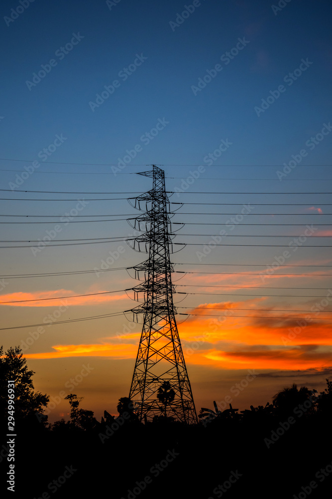 high voltage post,High voltage tower sky sunset background.Electric tower, silhouette at sunrise.