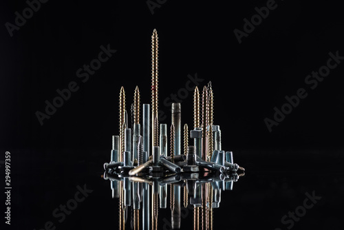 various shiny metallic screws isolated on black