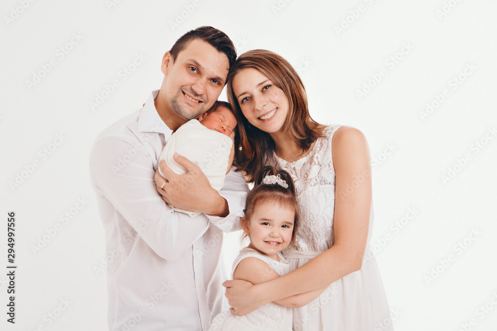 family photo on a white background: parents spend time with their children. mom and dad hug the baby. the concept of childhood, fatherhood, motherhood, IVF family photo on a white background: parents spend time with their children. mom and dad hug the baby. the concept of childhood, fatherhood, motherhood, IVF