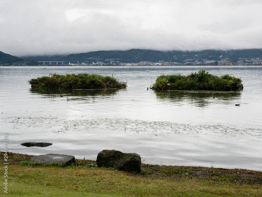 Rainy day on Lake Suwako with heavy clouds covering the surrounding mountains - Kamisuwa, Nagano prefecture, Japan